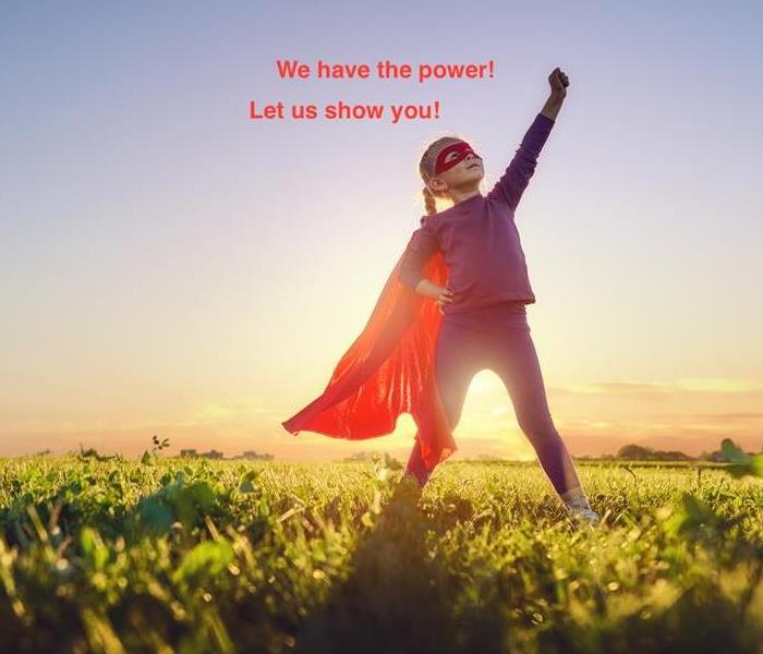 Little girl with a cape on, and her fist in the air. With words about power above her head. 
